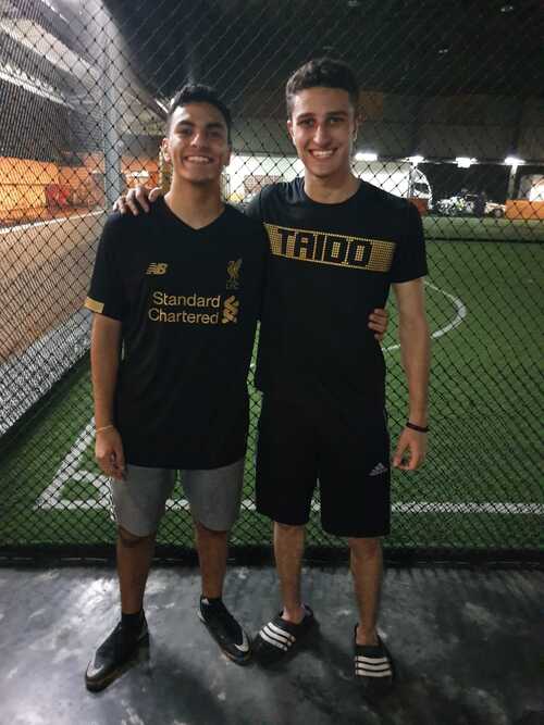 Hamza and his friend standing outside a futsal court after a futsal session